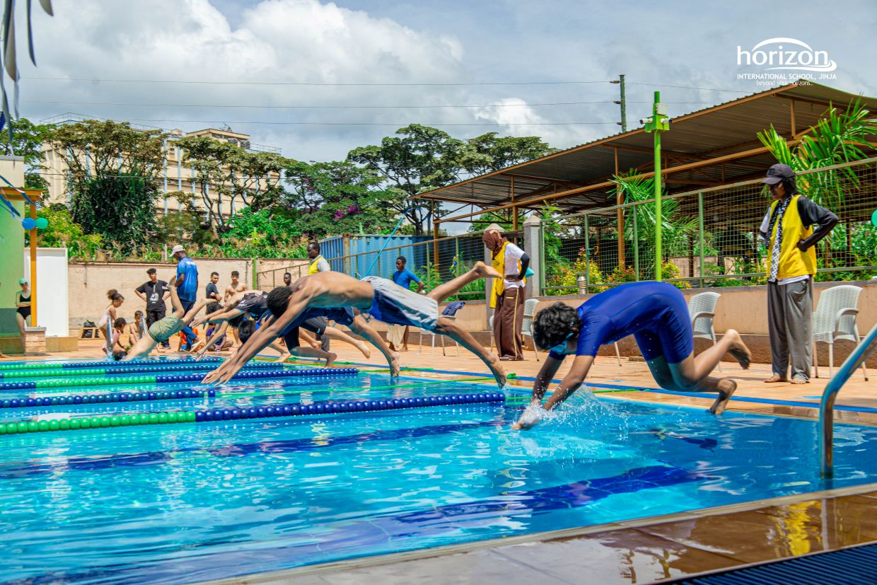 Secondary students diving into the pool during the Horizon Swimming Gala